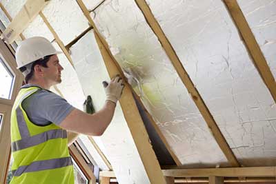 contractor installing aluminum roof insulation